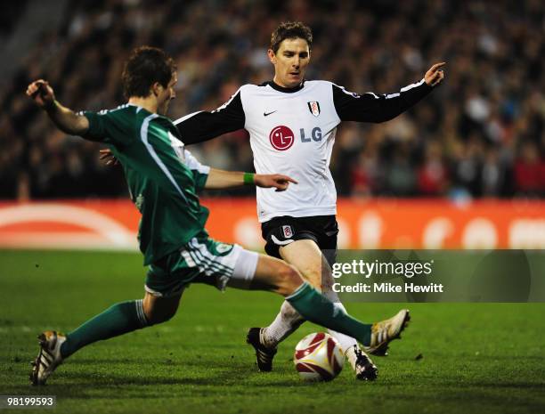 Zoltan Gera of Fulham is tackled by Peter Pekarik of VfL Wolfsburg during the UEFA Europa League quarter final first leg match between Fulham and Vfl...