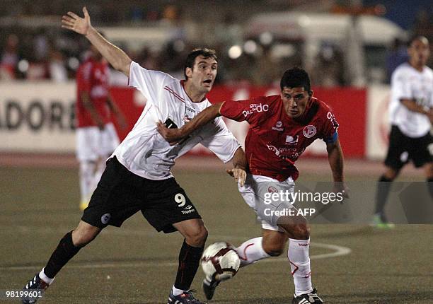 Argentina´s Mauro Boselli from Estudiantes de La Plata vies for the ball against Jesus Alvarez from Peru´s Juan Aurich during their Copa Libertadores...