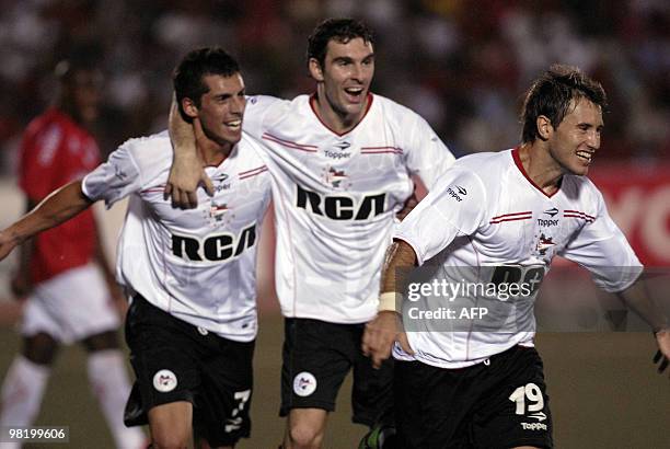 Argentina's Nicolas Fernandez from Estudiantes de La Plata celebrates with teammate Jose Sosa and Mauro Boselli after scoring against Peru's Juan...