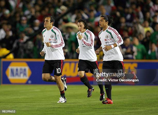 Cuauhtemoc Blanco, Andres Guardado and Giovani Dos Santos of Mexico jog onto the field for warm-up prior to their International Friendly match...