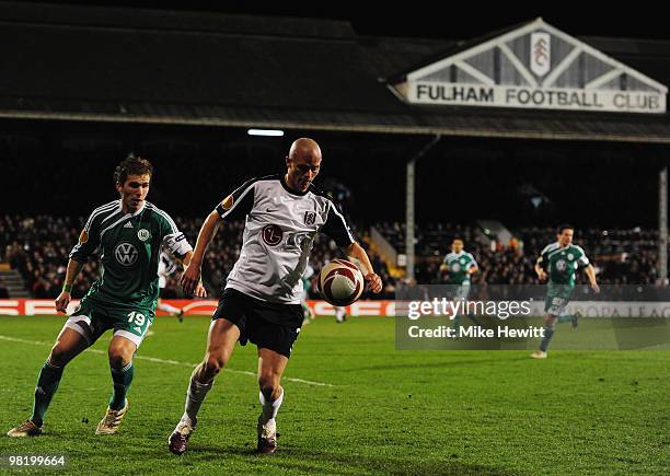 Paul Konchesky of Fulhamis watched by Peter Pekarik of VfL Wolfsburg during the UEFA Europa League quarter final first leg match between Fulham and...