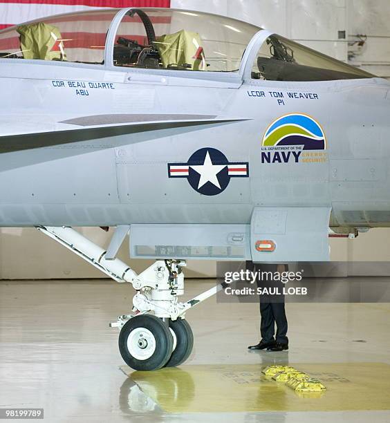 President Barack Obama examines a F-18 "Green Hornet," fueled by advanced biodiesel, after speaking on energy security at Joint Base Andrews Naval...