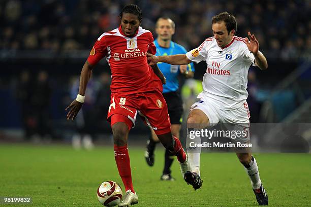 Dieudonne Mbokani of Liege and Joris Mathijsen of Hamburg battle for the ball during the UEFA Europa League quarter final first leg match between...