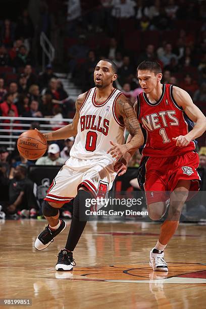 Acie Law of the Chicago Bulls drives the ball downcourt against Chris Quinn of the New Jersey Nets during the game on March 27, 2010 at the United...