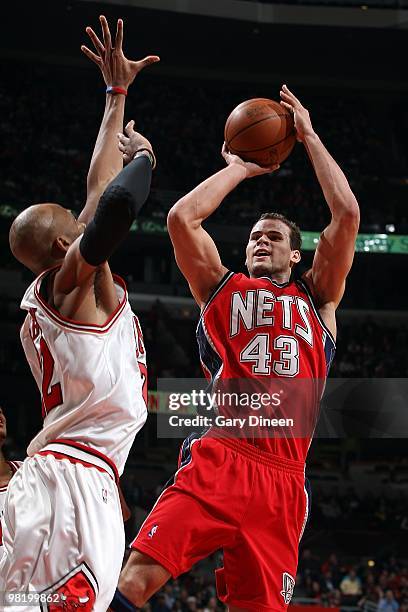 Kris Humphries of the New Jersey Nets shoots against Taj Gibson of the Chicago Bulls during the game on March 27, 2010 at the United Center in...