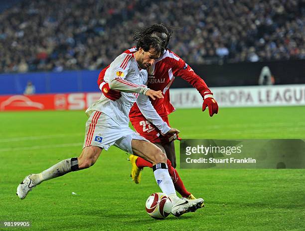 Ruud van Nistelrooy of Hamburg is challenged by Eliaquim Mangala of Liege during the UEFA Europa League quarter final, first leg match between...