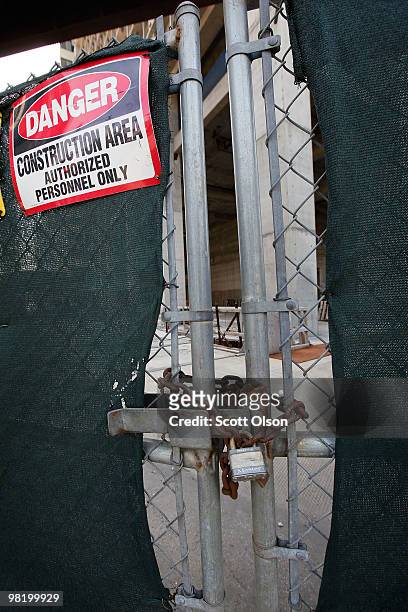 Rusted chain secures the gate of a vacant worksite for the proposed Waterview Tower hotel and condominium project April 1, 2010 in downtown Chicago,...