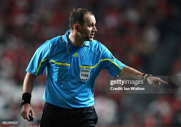 Referee Jonas Eriksson signals during the UEFA Europa League quarter final first leg match between Benfica and Liverpool at Estadio da Luz Stadium on...