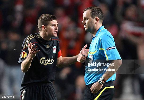 Steven Gerrard of Liverpool speaks to referee Jonas Eriksson during the UEFA Europa League quarter final first leg match between Benfica and...