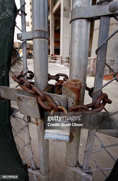 Rusted chain secures the gate of a vacant worksite for the proposed Waterview Tower hotel and condominium project April 1, 2010 in downtown Chicago,...