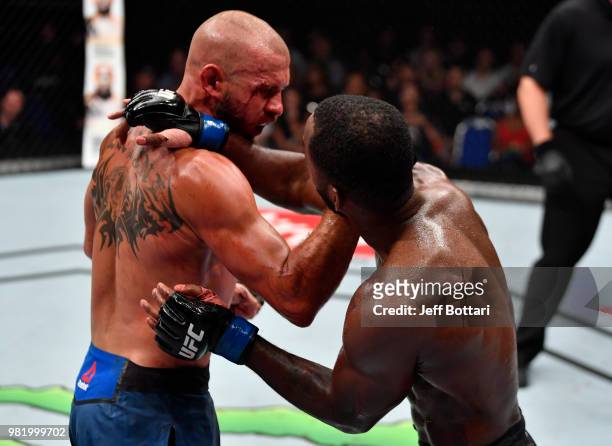 Donald Cerrone punches Leon Edwards of Jamaica in their welterweight bout during the UFC Fight Night event at the Singapore Indoor Stadium on June...