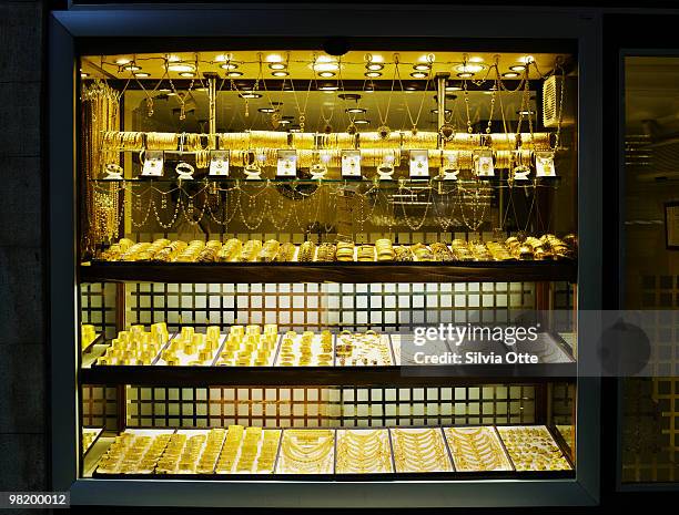 display of gold jewelry in shop window - silvia otte stock pictures, royalty-free photos & images