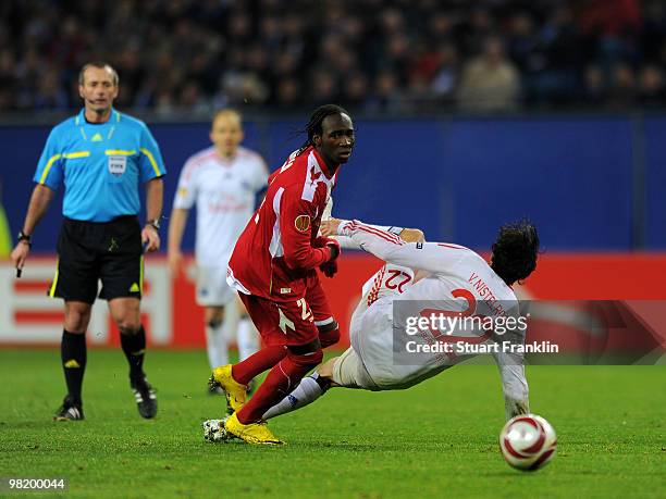 Ruud van Nistelrooy of Hamburg gets injured in challenge by Eliaquim Mangala of Liege during the UEFA Europa League quarter final, first leg match...