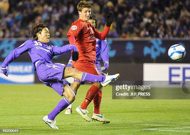 Japan's Sanfrecce Hiroshima forward Masato Yamazaki shoots the ball, while Australia's Adelaide United defender Michael Marrone blocks during the AFC...