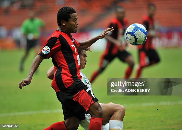 Stevie Glory Melianus of Indonesia's Persipura Jayapura vies for the ball with an unidentified Kashima Antlers player during their AFC champion's...