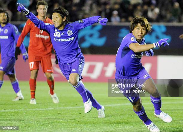 Japan's Sanfrecce Hiroshima forward Masato Yamazaki celebrates his team-mate Hisato Sato's goal during the first half of the AFC Champions League...