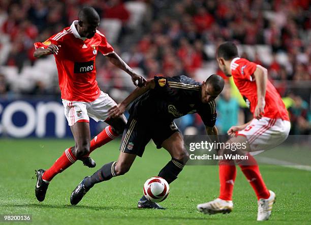 Ramires of Benfica attempts to tackle David Ngog of Liverpool during the UEFA Europa League quarter final first leg match between Benfica and...