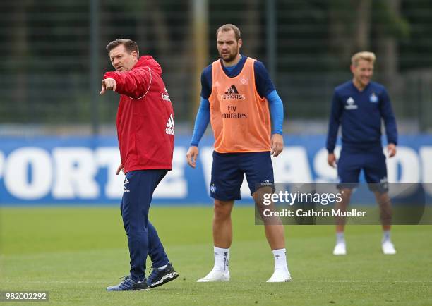 Christian Titz, head coach of Hamburger SV gestures and Pierre-Michel Lasogga looks on during the first training session of the new season at...