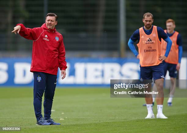 Christian Titz, head coach of Hamburger SV gestures and Pierre-Michel Lasogga looks on during the first training session of the new season at...