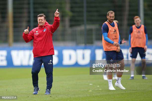 Christian Titz, head coach of Hamburger SV gestures and Pierre-Michel Lasogga looks on during the first training session of the new season at...