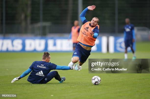 Goalkeeper Tom Mickel and Pierre-Michel Lasogga in action during the first training session of the new season at Volksparkstadion on June 23, 2018 in...