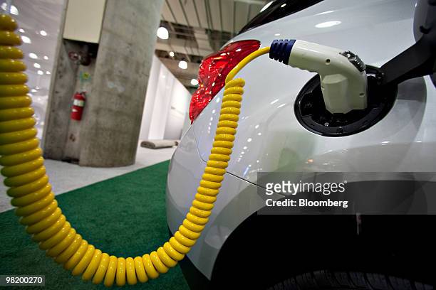 Charger sits plugged into a Chevrolet Equinox electric vehicle during a media preview of the New York International Auto Show in New York, U.S., on...