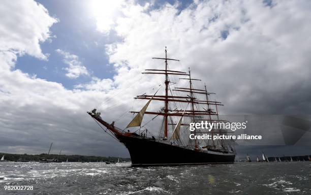 June 2018, Germany, Kiel: The Russian four-master 'Sedov' is on the Fjord during the windjammer parade at the Kieler Woche . There are considerably...