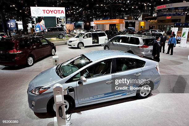 Toyota vehicles, including a plug-in Prius hybrid, center, sit on display during a media preview of the New York International Auto Show in New York,...