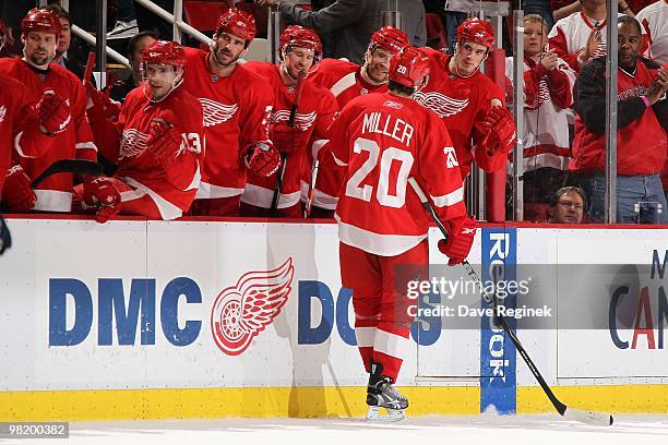 Drew Miller of the Detroit Red Wings celebrates his goal with teammates on the bench during an NHL game against the Edmonton Oilers at Joe Louis...