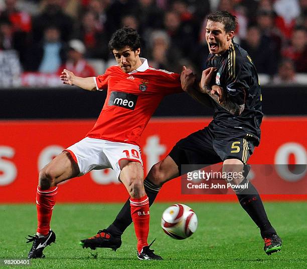 Daniel Agger of Liverpool competes with Pablo Aimar of Benfica during the UEFA Europa League quarter final first leg match between Benfica and...