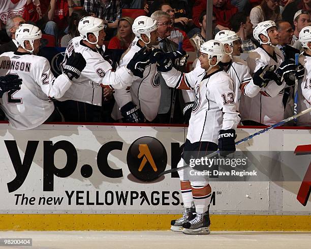 Andrew Cogliano of the Edmonton Oilers celebrates a goal with teammates on the bench during an NHL game against the Detroit Red Wings at Joe Louis...