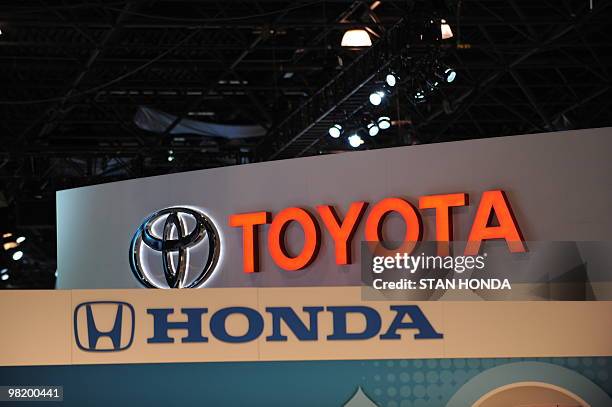 The logos for Toyota and Honda are seen at the New York International Auto Show on March 31, 2010 in New York. AFP PHOTO/Stan HONDA