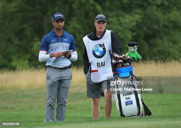 Aaron Rai of England looks on with his caddie during day three of the BMW International Open at Golf Club Gut Larchenhof on June 23, 2018 in Cologne,...