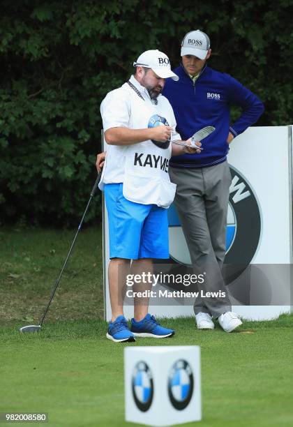 Martin Kaymer of Germany looks on with his caddie Craig Connelly during day three of the BMW International Open at Golf Club Gut Larchenhof on June...