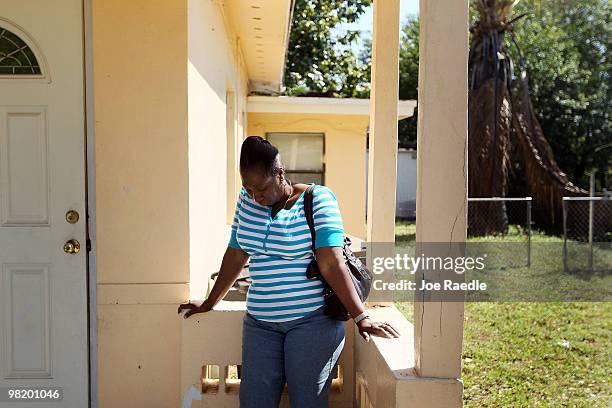 Gizelle Georges stands outside of the home she owns that is currently under foreclosure on April 1, 2010 in Miami, Florida. Having not made a payment...