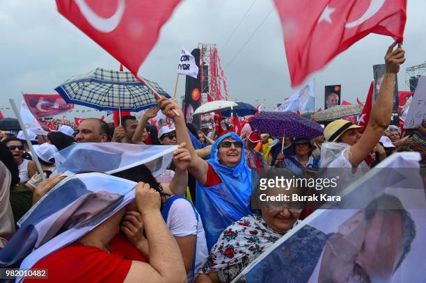 Supporters wave flags and cheer while listening to Muharrem Ince, presidential candidate of Turkey's main opposition Republican People's Party speak...