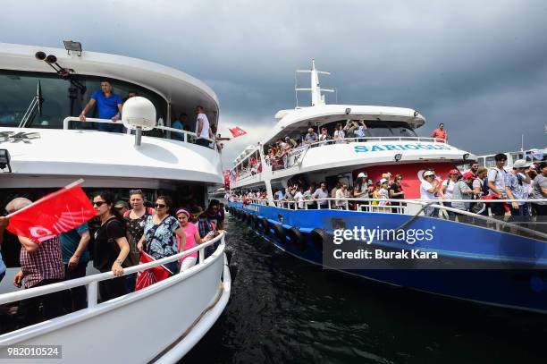 Supporters of Muharrem Ince, presidential candidate of Turkey's main opposition Republican People's Party stand on boats as they go to an election...