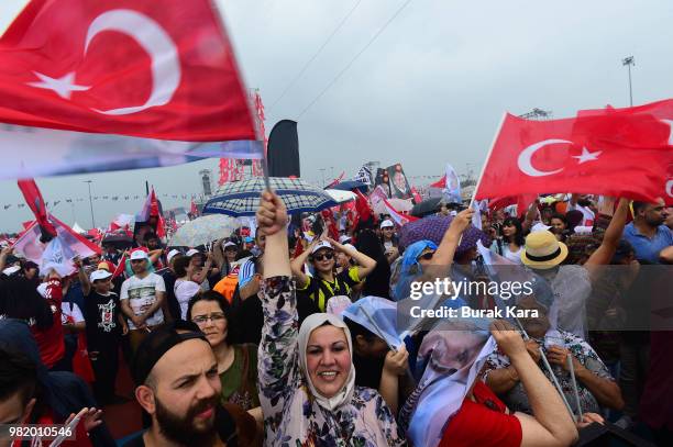 Supporters wave flags and cheer while listening to Muharrem Ince, presidential candidate of Turkey's main opposition Republican People's Party speak...