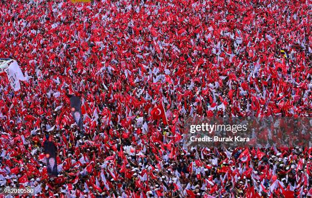 Supporters wave flags and cheer while listening to Muharrem Ince, presidential candidate of Turkey's main opposition Republican People's Party speak...