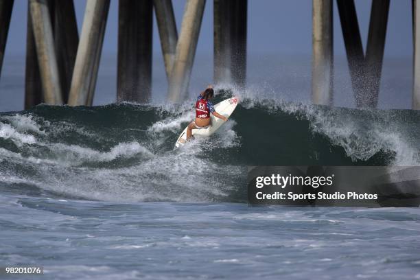 Female surfer rides a wave at the Hurley U.S. Open of Surfing on July 26, 2009 in Huntington Beach, California.