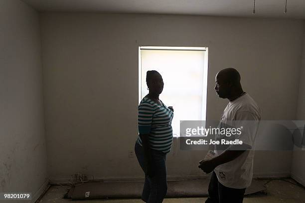 Gizelle Georges and her boyfriend Eddy Auguste stand inside of the home she owns currently under foreclosure on April 1, 2010 in Miami, Florida....