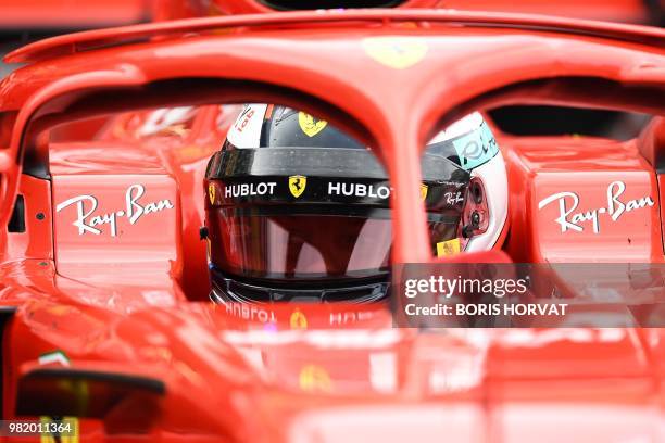 Ferrari's Finnish driver Kimi Raikkonen sits in his car in the pits during the qualifying session at the Circuit Paul Ricard in Le Castellet,...