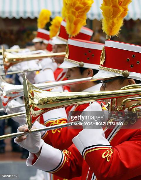 Marching band perform their trombones during the press preview for the new parade "Easter Bonnet Party" at the Tokyo Disneyland at Urayasu city,...