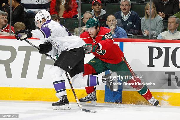 Nick Schultz of the Minnesota Wild defends against Dustin Brown of the Los Angeles Kings during the game at the Xcel Energy Center on March 29, 2010...