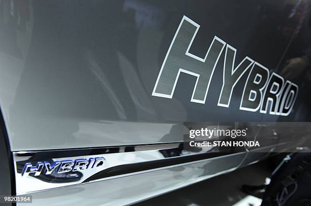 Hybrid logo on the doors of the Volkswagen Touareg Hybrid at the New York International Auto Show March 31, 2010 in New York. AFP PHOTO/Stan HONDA
