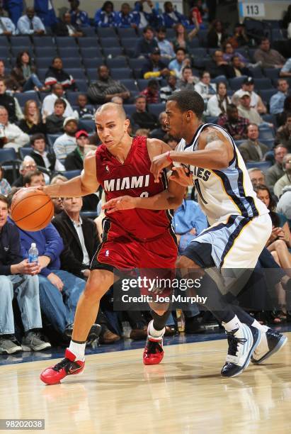 Carlos Arroyo of the Miami Heat drives against Mike Conley of the Memphis Grizzlies during the game on February 19, 2010 at FedExForum in Memphis,...