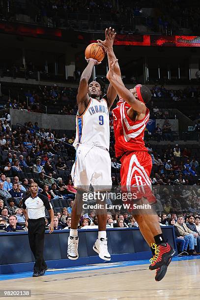 Serge Ibaka of the Oklahoma City Thunder shoots against Mike Harris of the Houston Rockets during the game on March 24, 2010 at the Ford Center in...