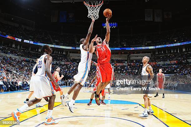 Mike Harris of the Houston Rockets goes to the basket against the Oklahoma City Thunder during the game on March 24, 2010 at the Ford Center in...