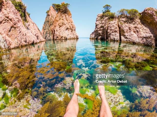 guy in a paradise transparent water in costa brava in the most hidden place. - debat fotografías e imágenes de stock