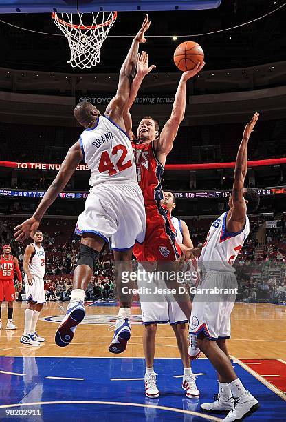 Kris Humphries of the New Jersey Nets goes to the basket against Elton Brand of the Philadelphia 76ers during the game on March 17, 2010 at Wachovia...